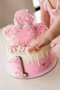 Crash pink cake at the celebration of the first birthday of the girl, ruined sponge cake, broken marshmallow, 1 year Royalty Free Stock Photo