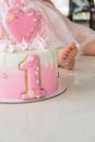 Crash pink cake at the celebration of the first birthday of the girl, ruined sponge cake, broken marshmallow, 1 year Royalty Free Stock Photo