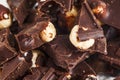 Crashed blach chocolate bar with large hazelnuts