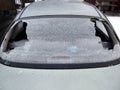 A crashed car heated rear window broken by an accidentally cast stone Royalty Free Stock Photo