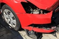 Crashed car of red color. Side view of the wrecked vehicle. The car crash. Traffic accident Royalty Free Stock Photo