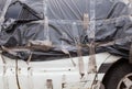 Crashed car wrapped in plastic sheeting