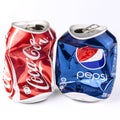 Crashed Coca Cola and Pepsi cans isolated on white Royalty Free Stock Photo