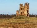 Crashed desolated old red brick medieval watch tower on hill in field Royalty Free Stock Photo