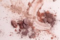 Crashed eyeshadow. Macro texture of make-up on beige background. Royalty Free Stock Photo