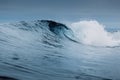 Crashing glassy wave on sandy beach. Perfect swell for surfing