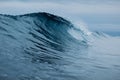 Crashing glassy wave on sandy beach. Perfect swell for surfing