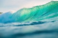 Crashing ocean wave. Breaking barrel wave with sunset light