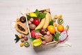 Crate and different exotic fruits on white wooden table, flat lay Royalty Free Stock Photo