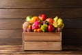 Crate with different exotic fruits on wooden table Royalty Free Stock Photo