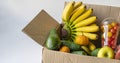 crate with fresh raw fruits to send as the donation to poor children