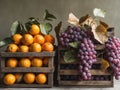 A crate of oranges sits next to a crate of grapes Royalty Free Stock Photo