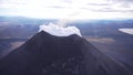 The crater of Karymsky volcano on the Kamchatka Peninsula thick white smoke