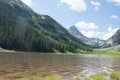 Crater Lake in Maroon Bells Snowmass Wilderness in Aspen Colorado with a blue sky and clouds in summer Royalty Free Stock Photo