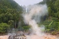 Crater Volcanic mud pools in Azores surrounded by green forest hot spring steam Royalty Free Stock Photo