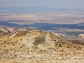 Craters of mud volcanoes in the background of the semi-desert. Royalty Free Stock Photo