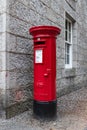 Classic red Royal Mail postbox with royal insignia outside Balmoral Castle Royalty Free Stock Photo