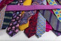 Close-up detailed background with colorful mens` neckties aqua, hot pink, burgundy, coral and orange with paisley pattern. Bright Royalty Free Stock Photo