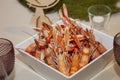 Crawfish cooked in white square porcelain platter on wedding banquet Royalty Free Stock Photo