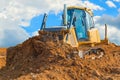 Crawler bulldozer - excavator with clipping path on a background with blue sky and clouds. work on construction site or sand pit Royalty Free Stock Photo