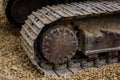 The Crawler close up , muddy crawler chain detail in earthy ambiance, Well used excavator tracks closeup