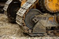 The Crawler close up , muddy crawler chain detail in earthy ambiance, Well used excavator tracks closeup