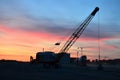 Crawler crane with a heavy metal wrecking ball on a steel cable. Wrecking balls at construction site. Dismantling and demolition