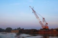 Crawler cranes used for rebuilding bridges near the river