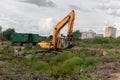 Crawler excavator digs the earth with a bucket.