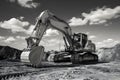 Crawler excavator at earthmoving works in black and white
