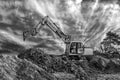 Crawler excavator during earthmoving works on construction site in black and white Royalty Free Stock Photo