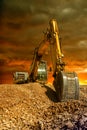 Crawler excavator during earthmoving works on construction site at sunset Royalty Free Stock Photo