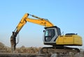 Crawler excavator with hydraulic breaker hammer for the destruction of concrete and hard rock at the construction site or quarry Royalty Free Stock Photo