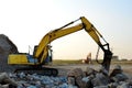 Crawler excavator with hydraulic breaker hammer for the destruction of concrete and hard rock at the construction site or quarry. Royalty Free Stock Photo