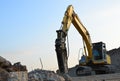 Crawler excavator with hydraulic breaker hammer for the destruction of concrete and hard rock at the construction site or quarry Royalty Free Stock Photo