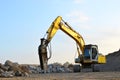 Crawler excavator with hydraulic breaker hammer for the destruction of concrete and hard rock at the construction site or quarry. Royalty Free Stock Photo