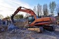 Crawler excavator with hydraulic breaker hammer for the destruction of concrete and hard rock at the construction site Royalty Free Stock Photo