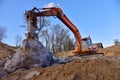 Crawler excavator with hydraulic breaker hammer for the destruction of concrete and hard rock at the construction site or quarry Royalty Free Stock Photo