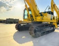 Crawler excavator with lift up bucket at construction site. Powerful excavator with an extended bucket close-up at the sunset.