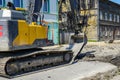 Crawler excavator use bucket to breaks up the old asphalt layer during street reconstruction Royalty Free Stock Photo