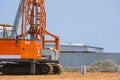 Pile driver machine lifting concrete piling for install industrial building structure in construction site