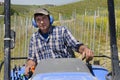 Crawler tractor driver works among the rows of vineyards