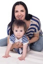 Crawling baby girl with mother playing on floor, isolated Royalty Free Stock Photo