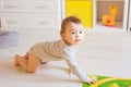 Crawling funny baby boy indoors at home