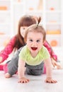 Crawling pigtailed toddler girl playing