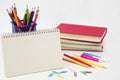 Crayon or colored pencils in box with side stack of books and school supplies on with background.. Royalty Free Stock Photo