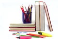 Crayon or colored pencils in box with side stack of books and school supplies. Royalty Free Stock Photo