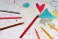 Crayons lying on a paper with heart drawing