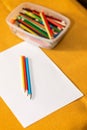 Crayons and paper on the desk Royalty Free Stock Photo