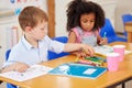 Crayons, paper, and you are set for hours of fun. preschool students colouring in class. Royalty Free Stock Photo